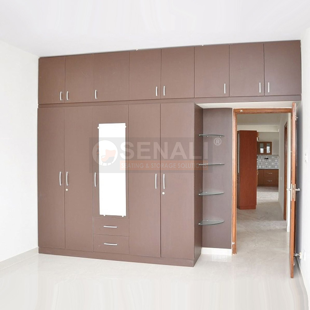 Space-saving bedroom wardrobe design in Chennai featuring an attached dresser unit